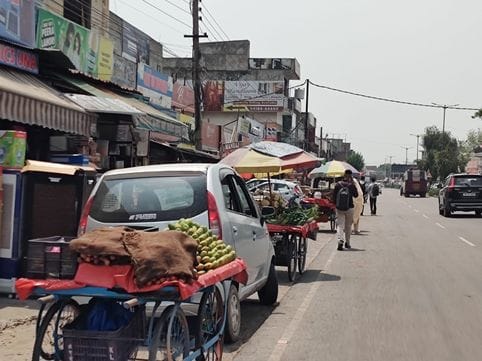 Claims air, goods on the sidewalk, pedestrians on the road