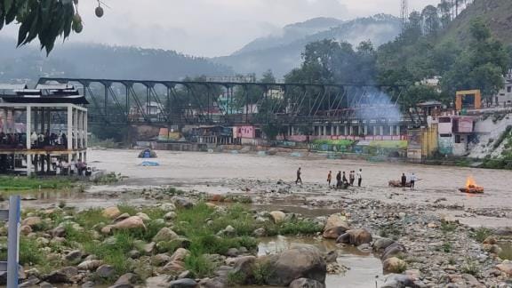 As the water level of Saryu river increased, the half-burnt body started floating