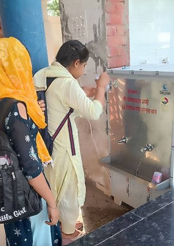 Social worker installed water cooler at bus stand
