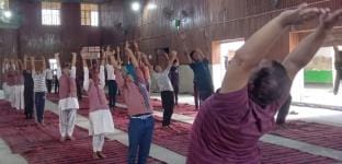 Training given to reduce obesity through yoga practice
