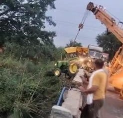 Container collided, tractor-trolley hanging on the railing of the bridge