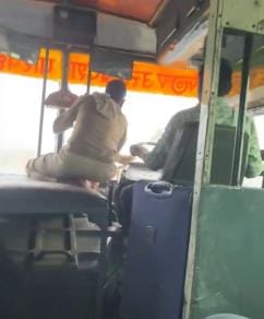 Cleaning the glass manually in a moving bus during rain