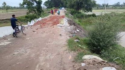 Bridge being constructed in rain, roadside cut at several places