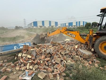 Bulldozer runs on illegal construction