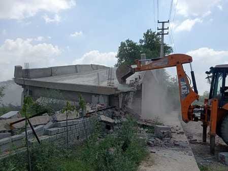 The district town planner's team ran a bulldozer on illegal construction