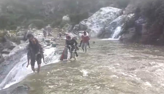 Students risking their lives to go to school by crossing the ditch