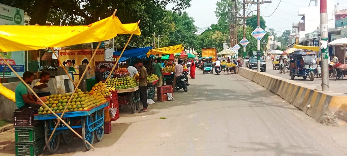 The southern road of Potterganj market surrounded by fruit and vegetable carts