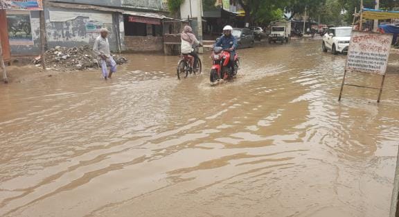 Rain water filled in houses and shops on the main road of Khukhundoo town
