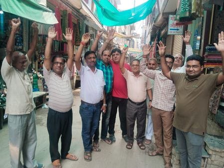 Traders troubled by rain water entering shops staged a protest