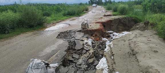 Road collapsed due to rain...deep potholes everywhere, risk of accident
