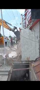 The encroachment was removed from the drain, now the municipality will collect the fine