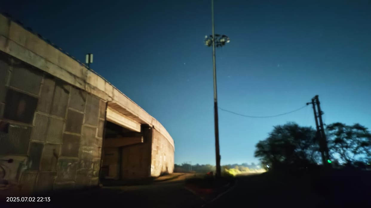 The high mast light remains off under the bridge throughout the night