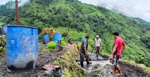 Farmers planting paddy by storing water in drums