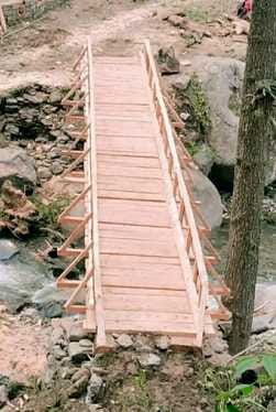 A bridge was made from the wood that was washed away by the flood in Ghatehad