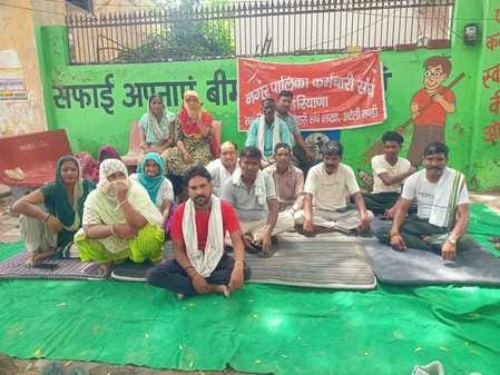 Cleaning workers demonstrated outside the Nagar Palika office in Ateli