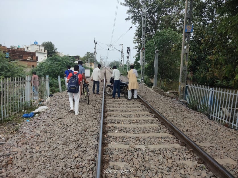 People are removing vehicles from the railway track due to water filling in the underbridge