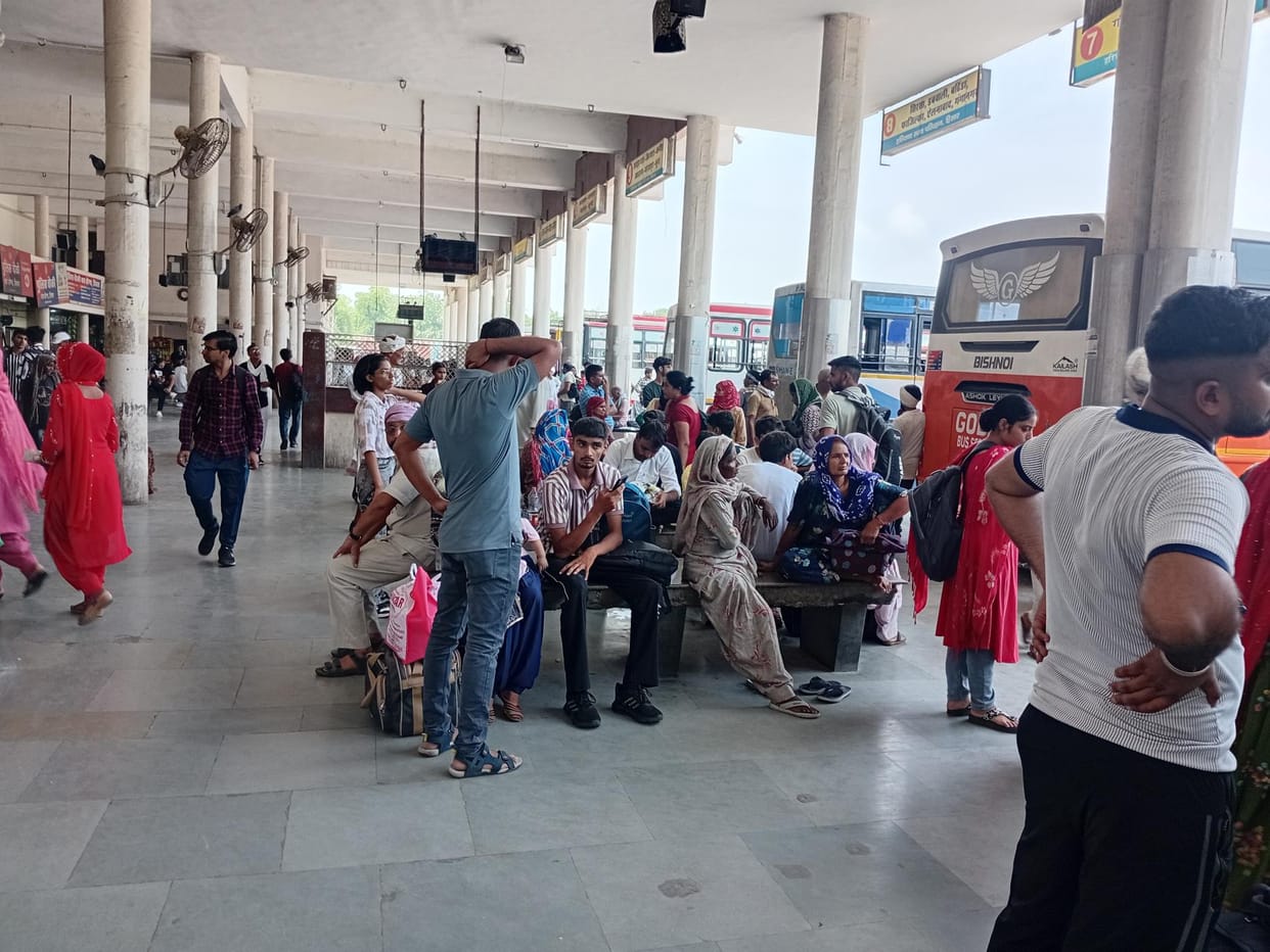 Passengers wandering around waiting for buses