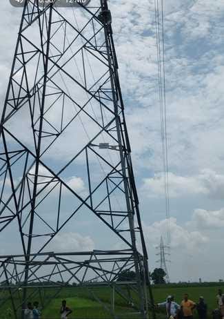 A young man climbed a high tension line tower in his insistence to take his wife with him