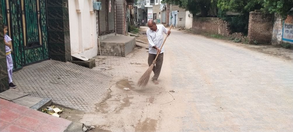 The retired principal cleans the area around his house every day