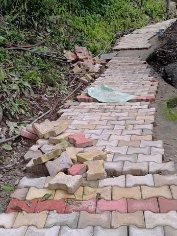 Interlock tiles could not be laid on 200 meters of road in one month