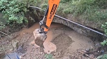 Debris removed from under the bridge on Bajoor drain of Bhota