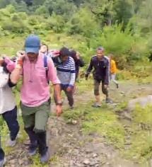 injured Diwakar. carried. shoulders. road. eight kilometers.