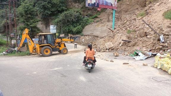 Landslide. near. Lakshmeshwar. two scooter riders. boulder.