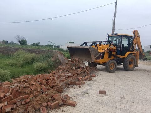 Bulldozer runs on the colony being built on four acres
