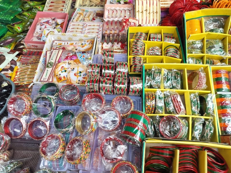 Wrists are adorned with green bangles of golden dots, craze for mehndi too