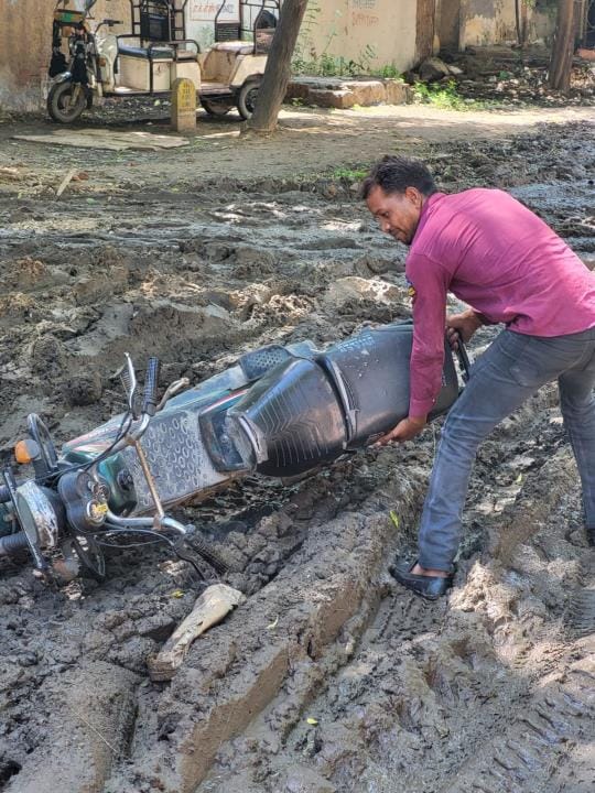 The lane of the industrial area is in bad shape, vehicles get stuck in the swamp