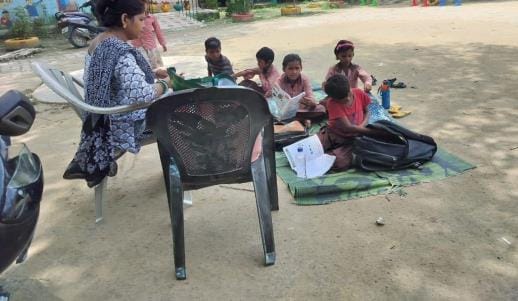 Classes are being held somewhere in a dilapidated building and somewhere nearby