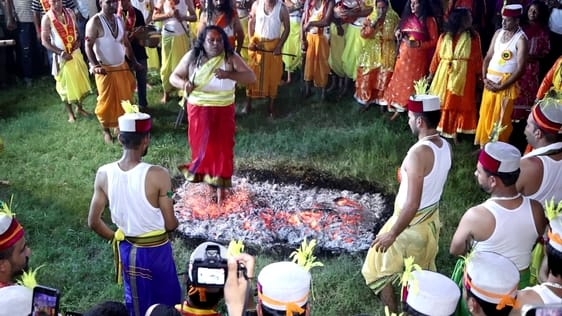 The Guru and disciples of the mother walk barefoot on burning embers