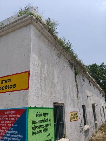 Children studying under leaking roofs in the rain, walls also dilapidated