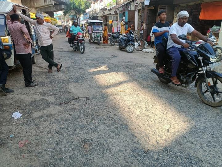 The road leading from the underpass is dilapidated, there are potholes everywhere