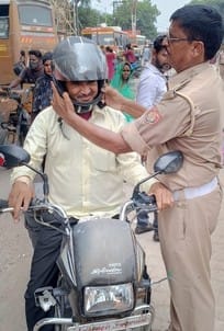 Lesson of traffic rules given by giving helmet