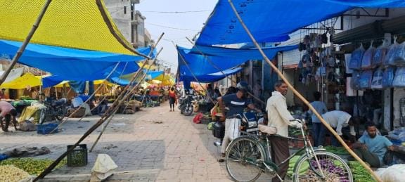 Construction of the market is incomplete, vegetable shops are being set up on the roads