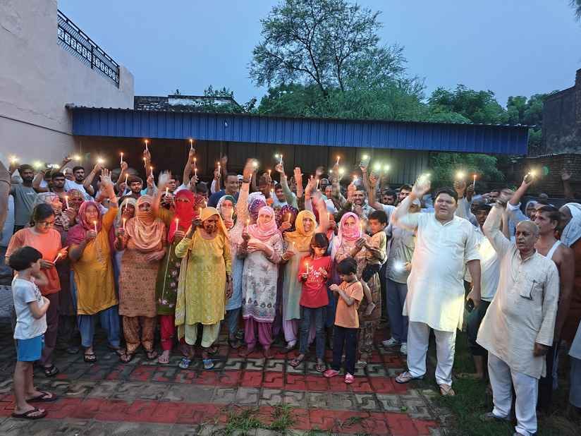 Even rain could not stop the public meeting and candle march