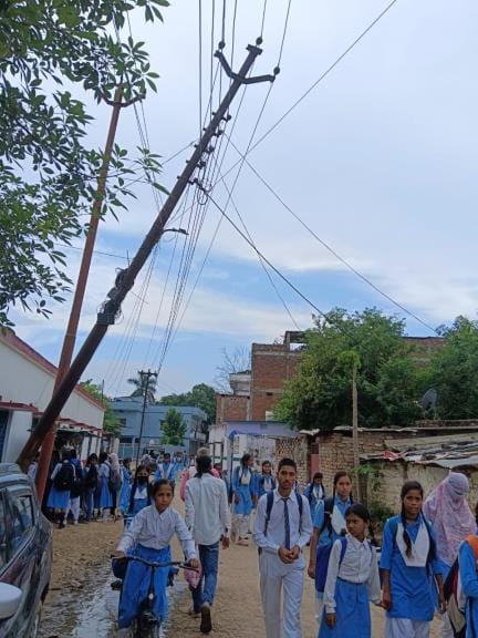 How is the school: Classes are being held under high tension wires, poles and transformers installed near the gate