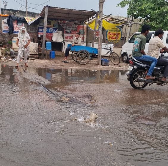 Contaminated water flowing on the road due to leaking pipe