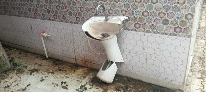 Water drips from the roof during rain, locks are hanging on toilets