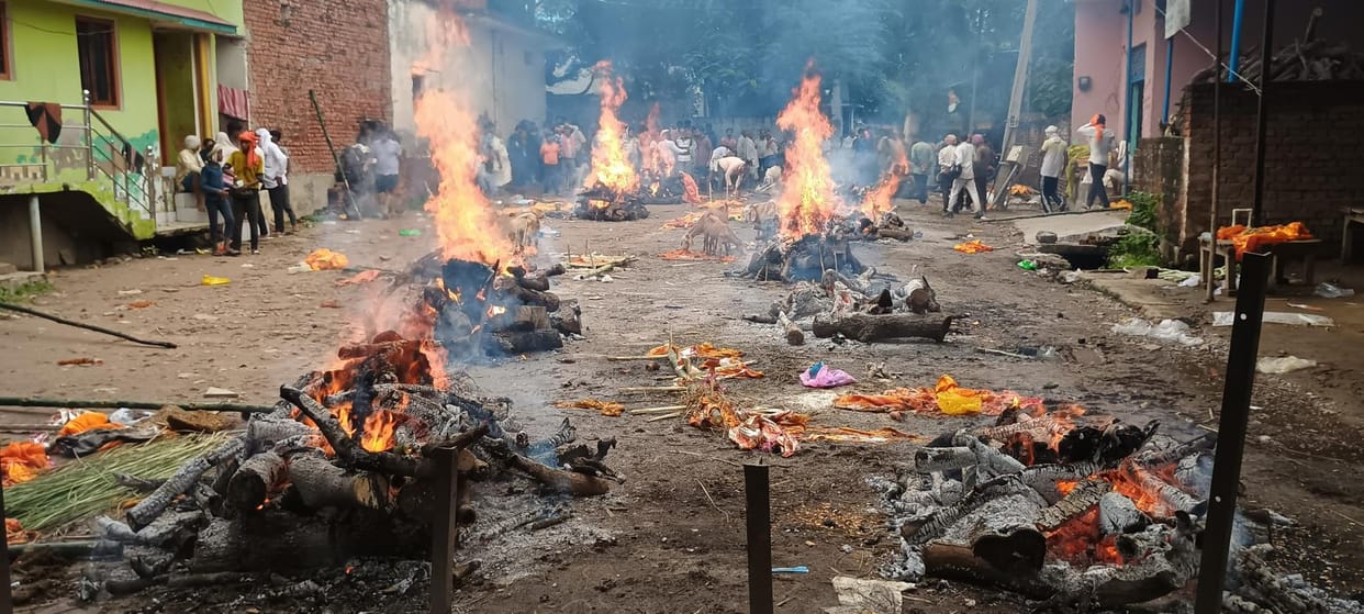 A pyre is burning in the street, flood water has entered the city