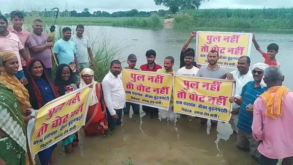 No bridge no vote protested by standing in flood water