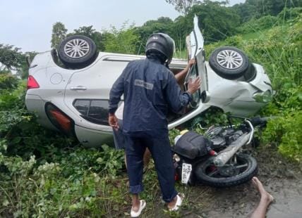 Car overturned after colliding with bike, two injured