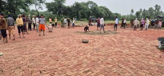 Workers were busy preparing the helipad amidst the rain