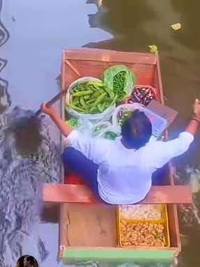 Selling vegetables from door to door in flood affected area by boat