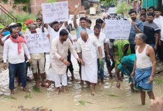 Protest by planting paddy on dilapidated road