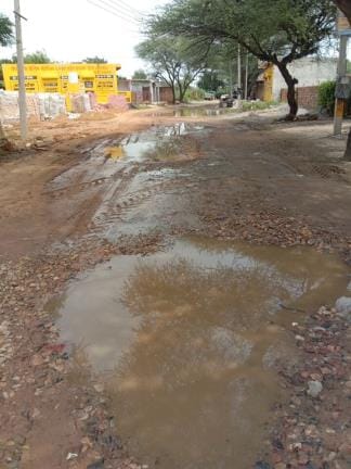 Road washed away in rain, life stuck in potholes