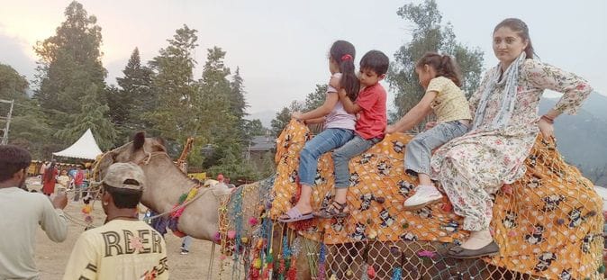Crowds are flocking for shopping, people are enjoying camel rides