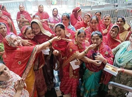 Women who have been protesting continuously for 70 days fed sweets to each other