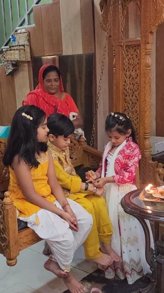 Sisters tie Rakhi on the wrists of their brothers